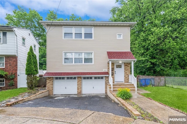 63 E Midland Ave, Kearny, NJ 07032 - view of front of home with driveway, an attached garage, and brick siding