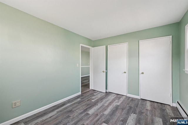 17 Cuozzo St Unit 27, Belleville, NJ 07109 - unfurnished bedroom featuring wood finished floors and baseboard heating