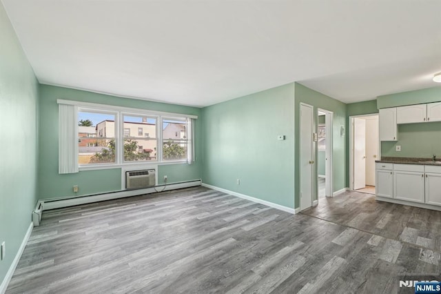 17 Cuozzo St Unit 27, Belleville, NJ 07109 - unfurnished living room featuring wood finished floors and a baseboard radiator