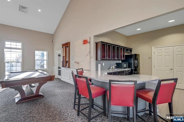23 Dahlia Ln Unit 23, Garfield, NJ 07026 - kitchen featuring black appliances, a breakfast bar, light countertops, recessed lighting, and a peninsula