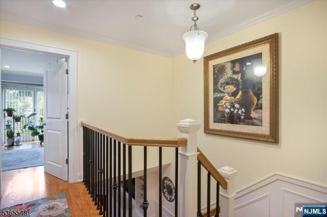 4 Lowell Ct Unit 704, Teaneck, NJ 07666 - hallway featuring an upstairs landing, wood finished floors, and crown molding