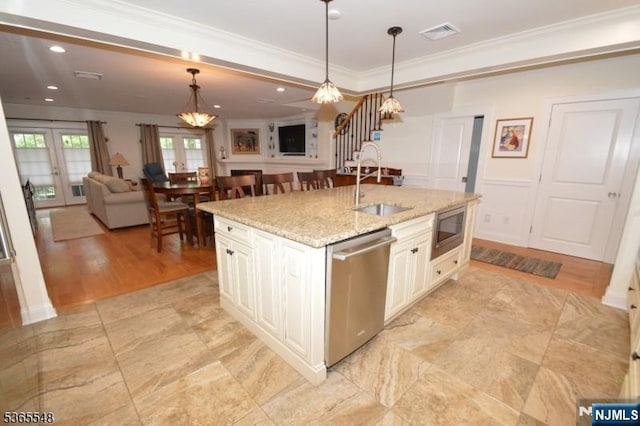 4 Lowell Ct Unit 704, Teaneck, NJ 07666 - kitchen with appliances with stainless steel finishes, ornamental molding, open floor plan, hanging light fixtures, and light stone countertops