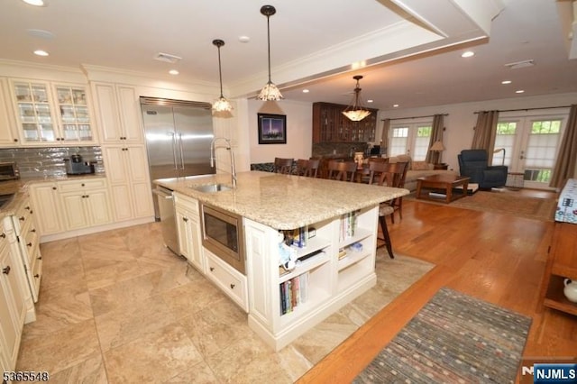 4 Lowell Ct Unit 704, Teaneck, NJ 07666 - kitchen featuring built in appliances, cream cabinets, ornamental molding, open shelves, and backsplash
