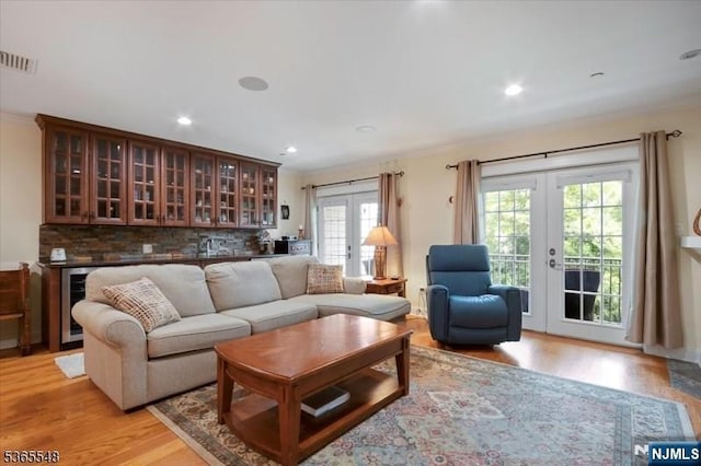 4 Lowell Ct Unit 704, Teaneck, NJ 07666 - living area with french doors, beverage cooler, bar with sink, light wood-type flooring, and recessed lighting