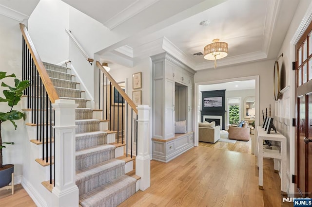 490 Ackerman Ave, Ho-Ho-Kus, NJ 07423 - foyer featuring light wood finished floors, stairs, ornamental molding, and a fireplace