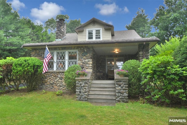 26 Monroe St, Waldwick, NJ 07463 - view of front of home with stone siding, a porch, and a front lawn