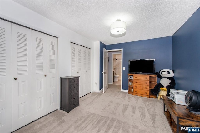462 Poets Way, Mahwah, NJ 07430 - bedroom featuring light colored carpet, two closets, and a textured ceiling