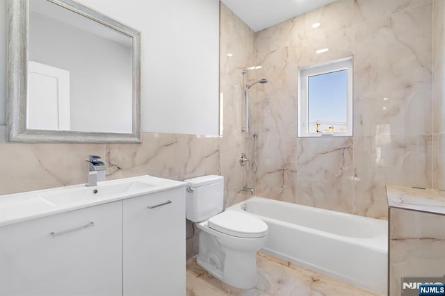 227 Wayne Ave Unit A, Cliffside Park, NJ 07010 - bathroom with tile walls, vanity, shower / washtub combination, and marble finish flooring