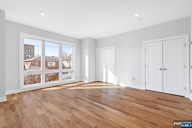 227 Wayne Ave Unit A, Cliffside Park, NJ 07010 - unfurnished bedroom featuring multiple closets, light wood-style floors, and recessed lighting
