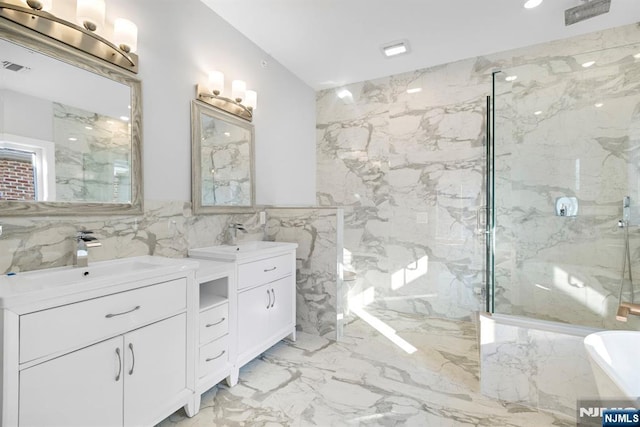 227 Wayne Ave Unit A, Cliffside Park, NJ 07010 - bathroom with tile walls, two vanities, a marble finish shower, marble tiled flooring, and a soaking tub