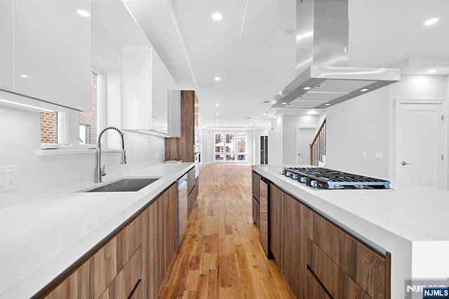 227 Wayne Ave Unit A, Cliffside Park, NJ 07010 - kitchen with modern cabinets, island range hood, stainless steel appliances, white cabinets, and healthy amount of natural light