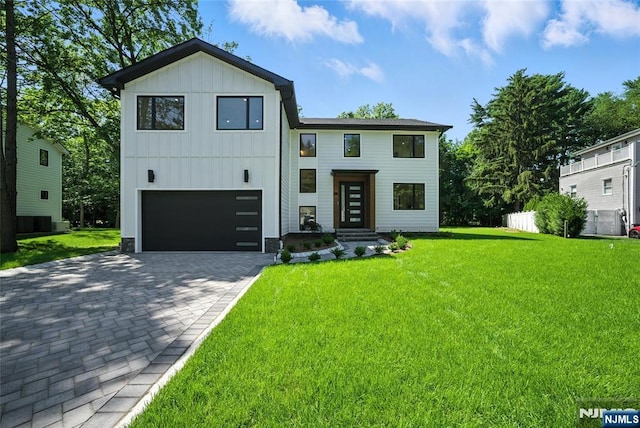 30 Benjamin Rd, Tenafly, NJ 07670 - contemporary house with an attached garage, board and batten siding, decorative driveway, and a front lawn
