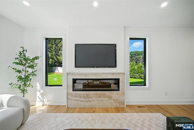 30 Benjamin Rd, Tenafly, NJ 07670 - living room with wood finished floors, recessed lighting, healthy amount of natural light, and a high end fireplace