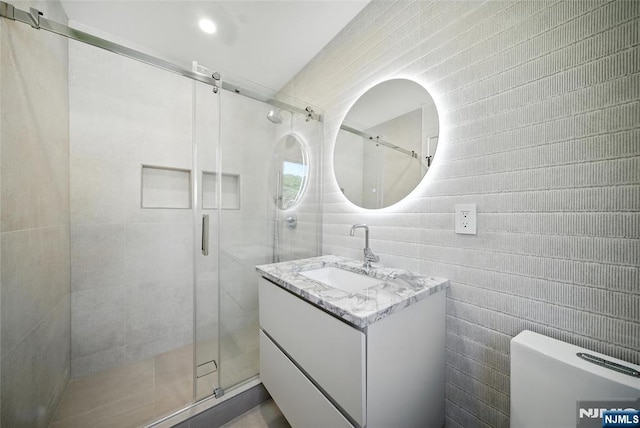 30 Benjamin Rd, Tenafly, NJ 07670 - full bath featuring vanity, a shower stall, and tile walls