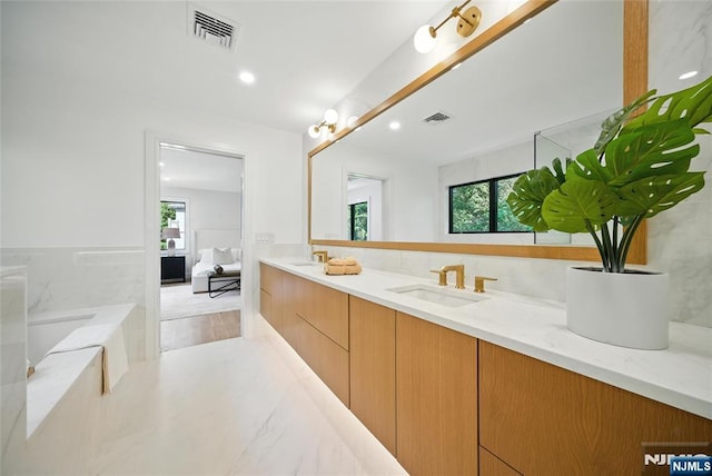 30 Benjamin Rd, Tenafly, NJ 07670 - full bathroom with double vanity, a bath, connected bathroom, and recessed lighting