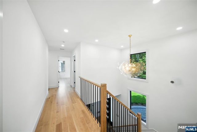 30 Benjamin Rd, Tenafly, NJ 07670 - hall with an upstairs landing, light wood finished floors, recessed lighting, and a chandelier