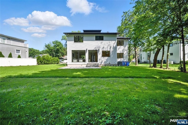 30 Benjamin Rd, Tenafly, NJ 07670 - back of property featuring a lawn and a patio