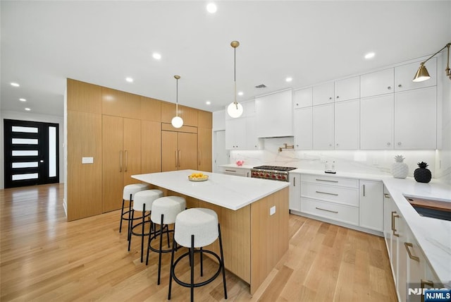 30 Benjamin Rd, Tenafly, NJ 07670 - kitchen with a kitchen island, light wood-style flooring, a kitchen bar, recessed lighting, and hanging light fixtures