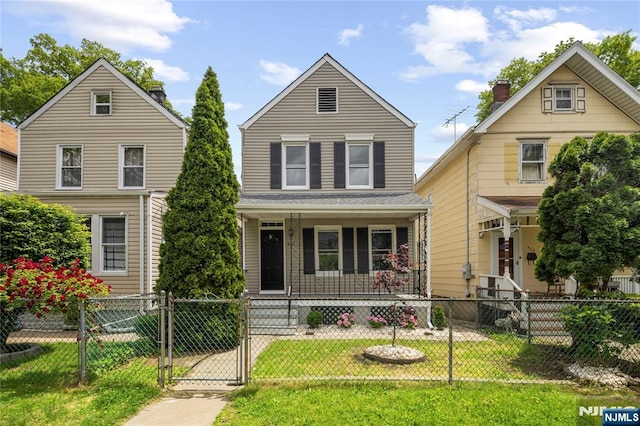 422 Davis Ave, Kearny, NJ 07032 - traditional-style house featuring a porch, a gate, and a fenced front yard