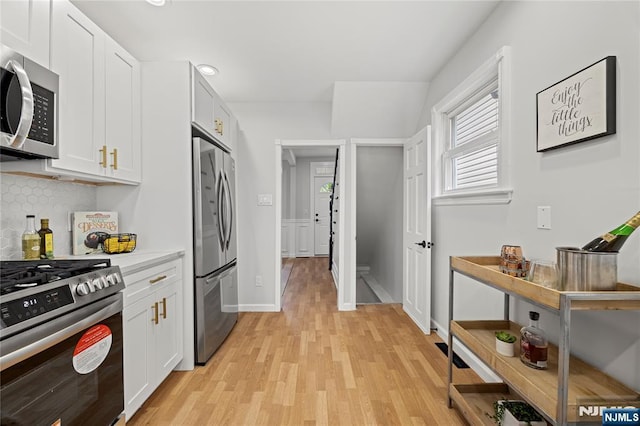 422 Davis Ave, Kearny, NJ 07032 - kitchen featuring appliances with stainless steel finishes, light wood-type flooring, light countertops, white cabinetry, and recessed lighting