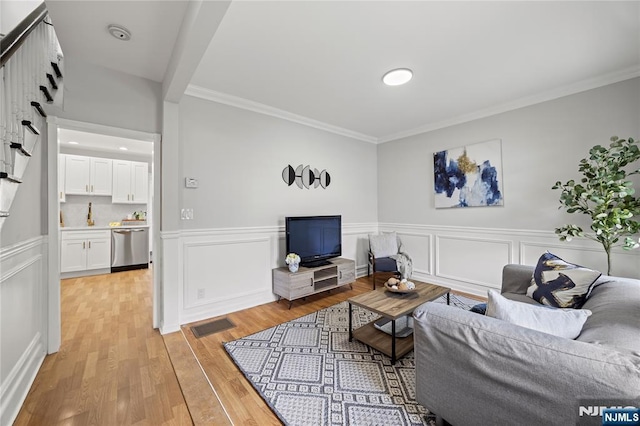 422 Davis Ave, Kearny, NJ 07032 - living area featuring ornamental molding, light wood-style flooring, and wainscoting