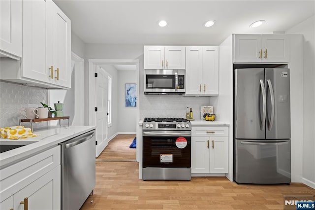 422 Davis Ave, Kearny, NJ 07032 - kitchen with stainless steel appliances, tasteful backsplash, light wood finished floors, recessed lighting, and white cabinets