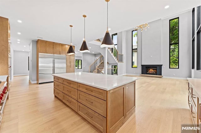 172 Birchwood, Old Tappan, NJ 07675 - kitchen with built in fridge, light wood finished floors, recessed lighting, a lit fireplace, and light countertops