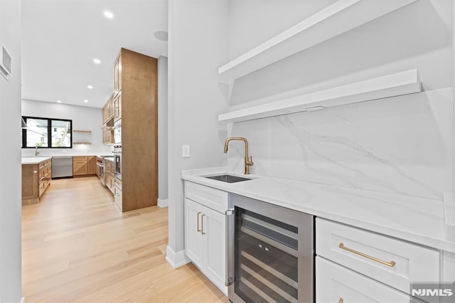 172 Birchwood, Old Tappan, NJ 07675 - indoor wet bar featuring beverage cooler, stainless steel dishwasher, light wood-style floors, and recessed lighting