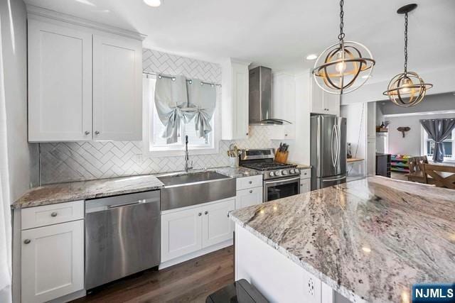 41 S Demarest Ave, Bergenfield, NJ 07621 - kitchen with stainless steel appliances, wall chimney exhaust hood, backsplash, white cabinetry, and dark wood finished floors