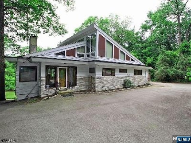 297 Terhune Dr, Wayne, NJ 07470 - rear view of house featuring a chimney and stone siding