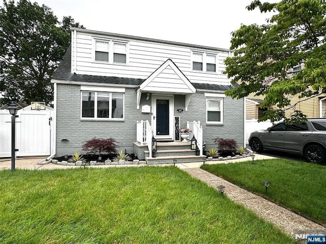 265 Wilson St, Saddle Brook, NJ 07663 - view of front of house featuring brick siding, a shingled roof, and a gate
