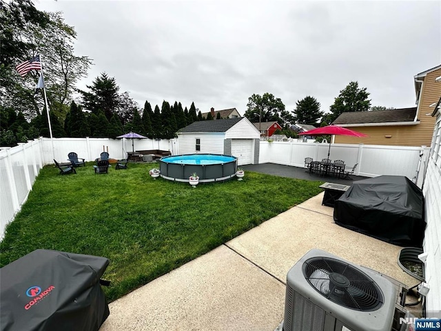265 Wilson St, Saddle Brook, NJ 07663 - fenced backyard featuring a patio, a detached garage, and an outbuilding