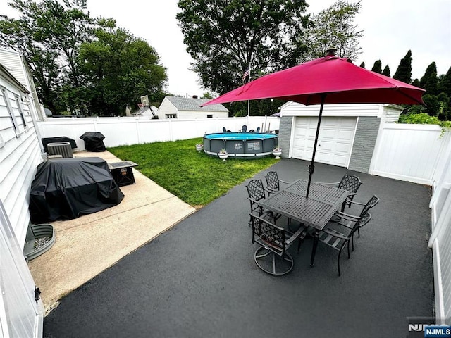265 Wilson St, Saddle Brook, NJ 07663 - fenced backyard with outdoor dining space, an outbuilding, a patio area, and grilling area