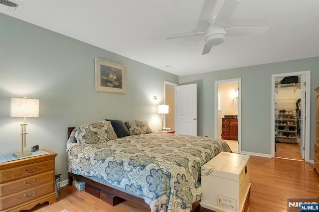 552 Godwin Ave, Midland Park, NJ 07432 - bedroom with light wood-style floors, a walk in closet, ensuite bath, a closet, and a ceiling fan