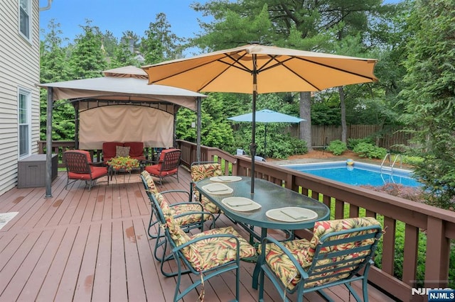 552 Godwin Ave, Midland Park, NJ 07432 - deck featuring a gazebo, view of wooded area, an outdoor living space, and outdoor dining area