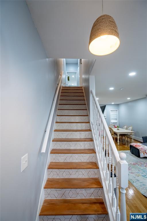 95 Mount Prospect Ave, Newark, NJ 07104 - staircase with wood finished floors and recessed lighting