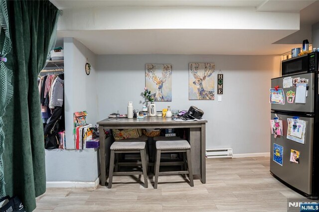 95 Mount Prospect Ave, Newark, NJ 07104 - dining area with a baseboard radiator and light wood-style flooring