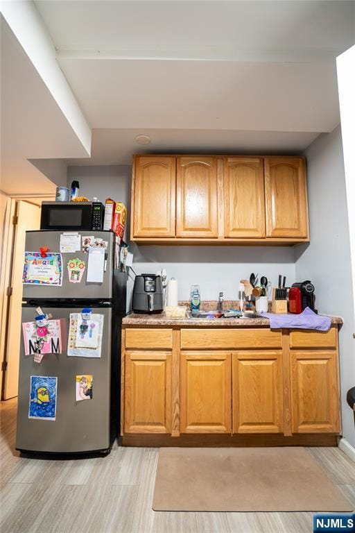 95 Mount Prospect Ave, Newark, NJ 07104 - kitchen with freestanding refrigerator, light wood finished floors, and light countertops
