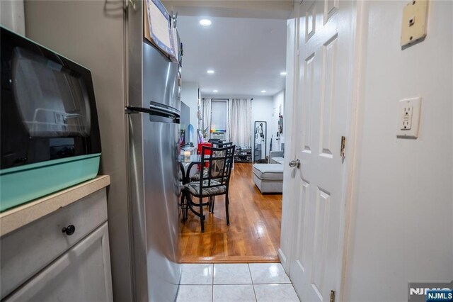 95 Mount Prospect Ave, Newark, NJ 07104 - kitchen featuring light tile patterned floors, recessed lighting, and freestanding refrigerator