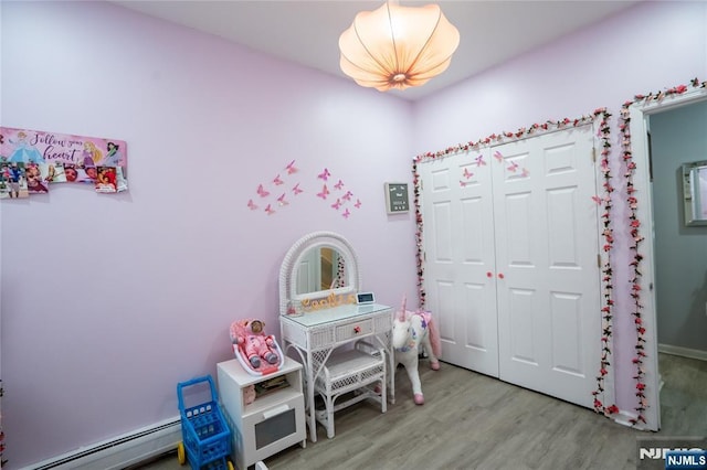 95 Mount Prospect Ave, Newark, NJ 07104 - rec room with a baseboard radiator and wood finished floors