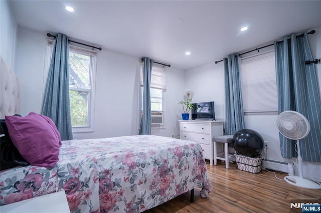 95 Mount Prospect Ave, Newark, NJ 07104 - bedroom with wood finished floors, recessed lighting, cooling unit, and a baseboard radiator