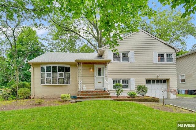 0-04 Pine Ave, Fair Lawn, NJ 07410 - split level home with a garage, asphalt driveway, a front lawn, and brick siding