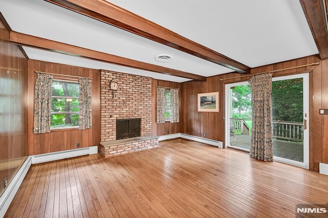 0-04 Pine Ave, Fair Lawn, NJ 07410 - unfurnished living room with a baseboard radiator, wood-type flooring, beam ceiling, wood walls, and healthy amount of natural light