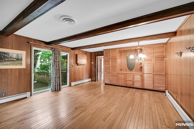 0-04 Pine Ave, Fair Lawn, NJ 07410 - unfurnished living room with a baseboard heating unit, beamed ceiling, hardwood / wood-style flooring, wood walls, and a chandelier