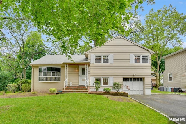0-04 Pine Ave, Fair Lawn, NJ 07410 - tri-level home with a garage, asphalt driveway, and a front yard