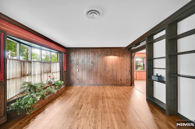 0-04 Pine Ave, Fair Lawn, NJ 07410 - empty room with light wood-type flooring and wood walls