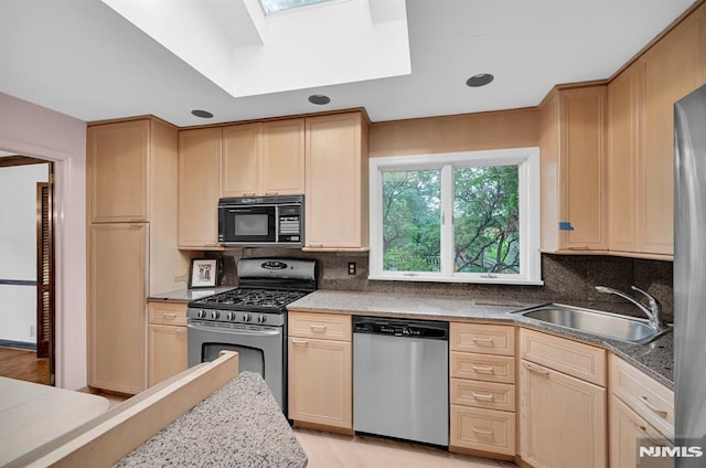 0-04 Pine Ave, Fair Lawn, NJ 07410 - kitchen with appliances with stainless steel finishes, a skylight, light brown cabinets, and decorative backsplash