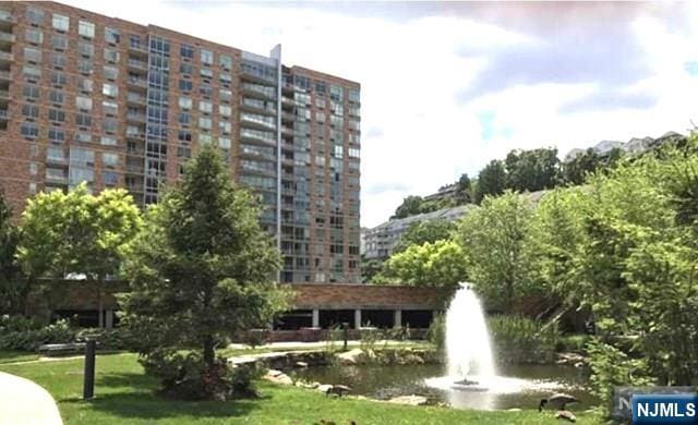 1611 Hudson Park Unit 1611, Edgewater, NJ 07020 - surrounding community featuring a water view and a lawn