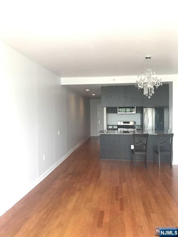 1611 Hudson Park Unit 1611, Edgewater, NJ 07020 - unfurnished living room featuring wood finished floors and a chandelier