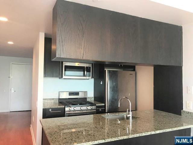 1611 Hudson Park Unit 1611, Edgewater, NJ 07020 - kitchen featuring appliances with stainless steel finishes, modern cabinets, dark wood-type flooring, light stone counters, and recessed lighting